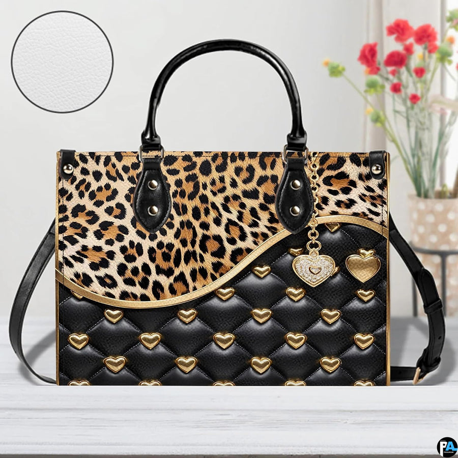 Front view of matching zip wallet with leopard print and quilted heart graphic design.