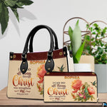 Coordinating handbag and matching zip wallet set displayed on a wooden table beside houseplant.