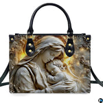 Front view of handbag showing detailed stone relief sculpture of Virgin Mary holding sleeping baby Jesus.