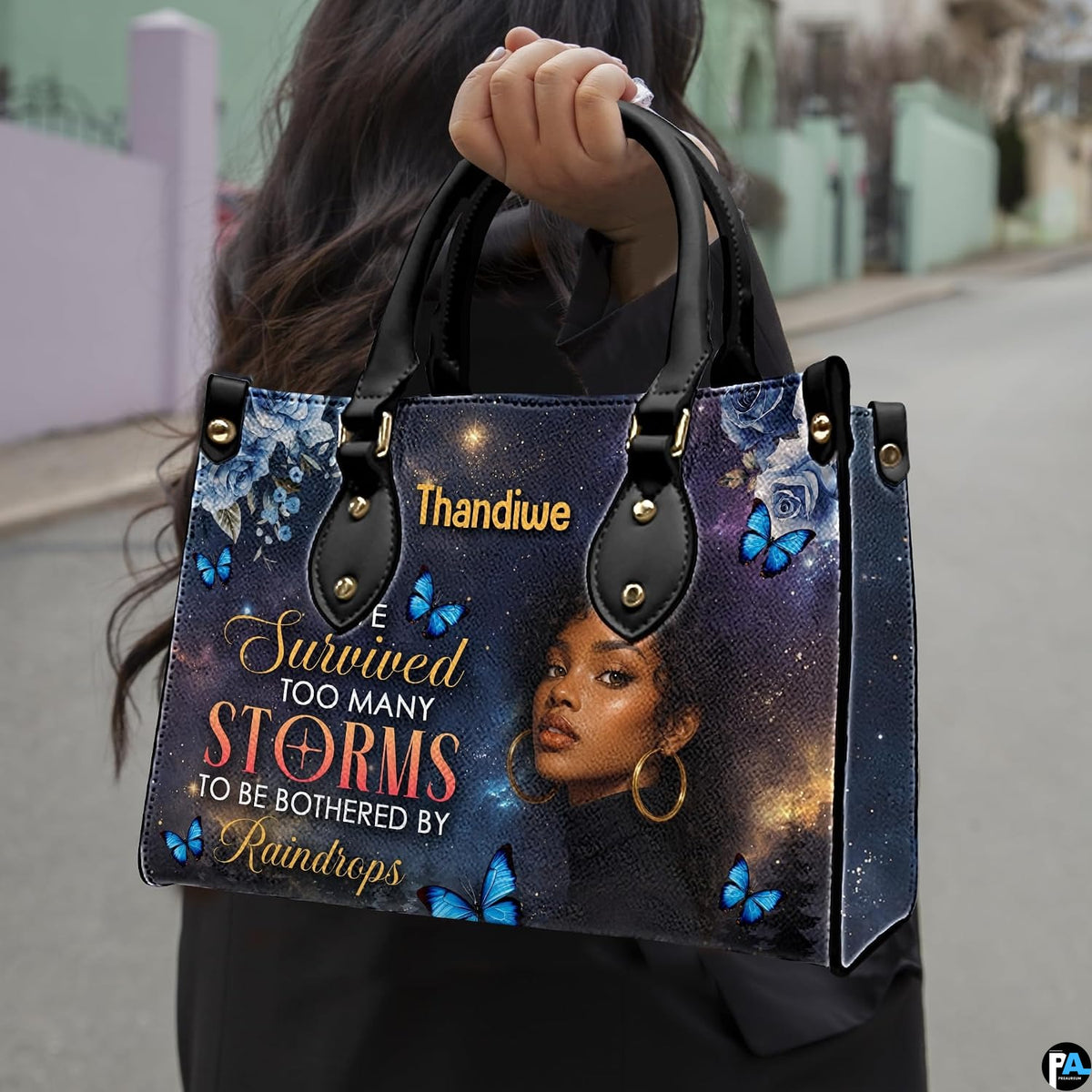 Outdoor pedestrian holding an accessory showcasing celestial woman painting during a daytime stroll.