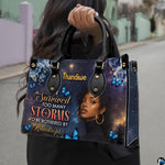 Outdoor pedestrian holding an accessory showcasing celestial woman painting during a daytime stroll.