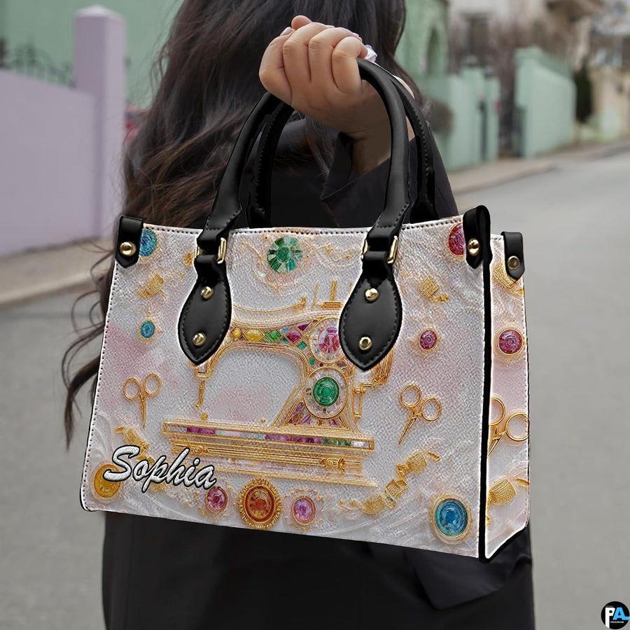 Model outdoors holding golden sewing machine artwork accessory in natural daylight.