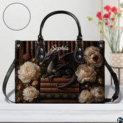 Top-down view of black dragon handbag showing full-length zipper closure opening