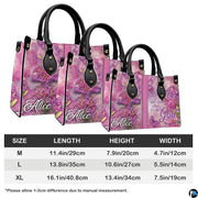 Perspective angle view of pink handbag highlighting side depth and continuous floral cross alignment.