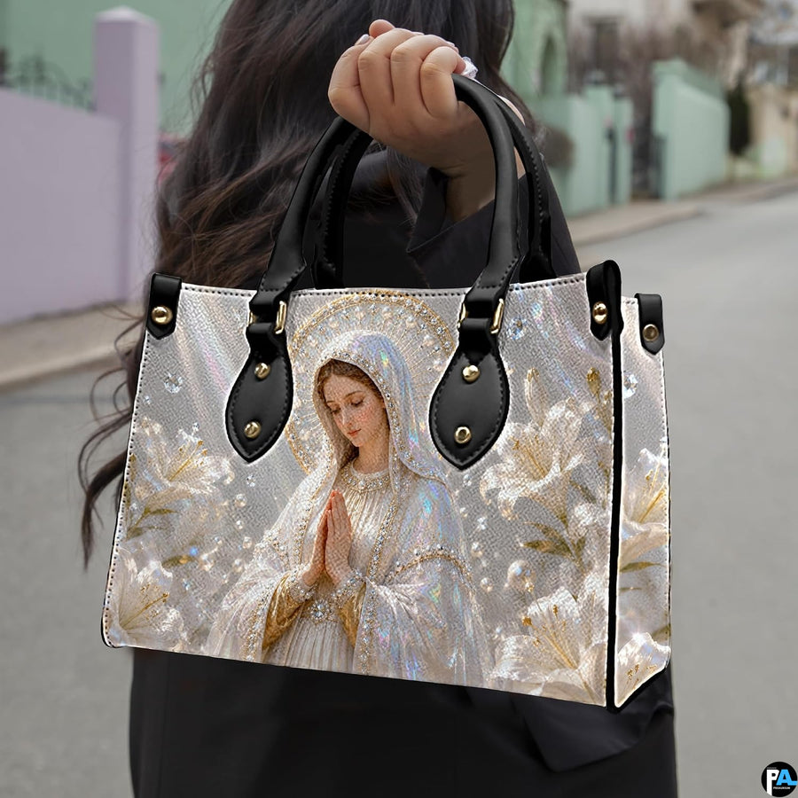 Side profile view of structured Madonna handbag showing silhouette and black carry handles