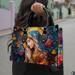 Lifestyle demonstration of the floral stained glass Mary handbag held outdoors
