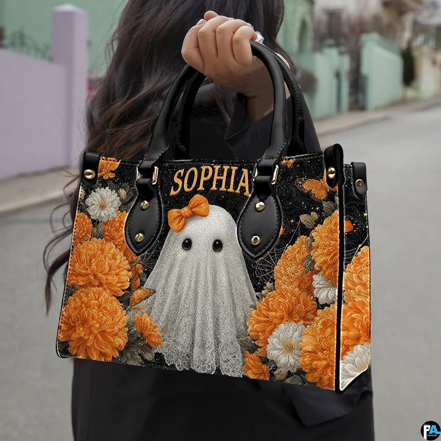 Daylight street presentation highlighting the vibrant ghost and botanical motif held in natural light.
