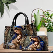 Coordinated sacred art duo positioned on tabletop beside green indoor plant.