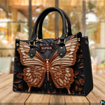 Sculpted bronze butterfly handbag standing on a wooden table in a cafe.