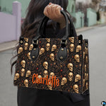 Outdoor street scene presenting the dark botanical skull graphic held in daylight against town scenery.
