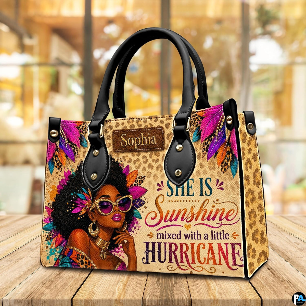 Perspective view showing the cheetah feather artwork on wooden surface before warm cafe window.