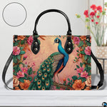 Peacock floral handbag with blush background and long black strap