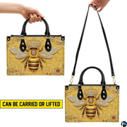 Top-down view of bee handbag showing dual handles and interior storage opening.