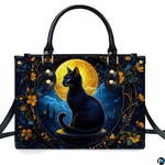 Front studio view showing black cat seated before glowing golden harvest moon in gothic floral frame.