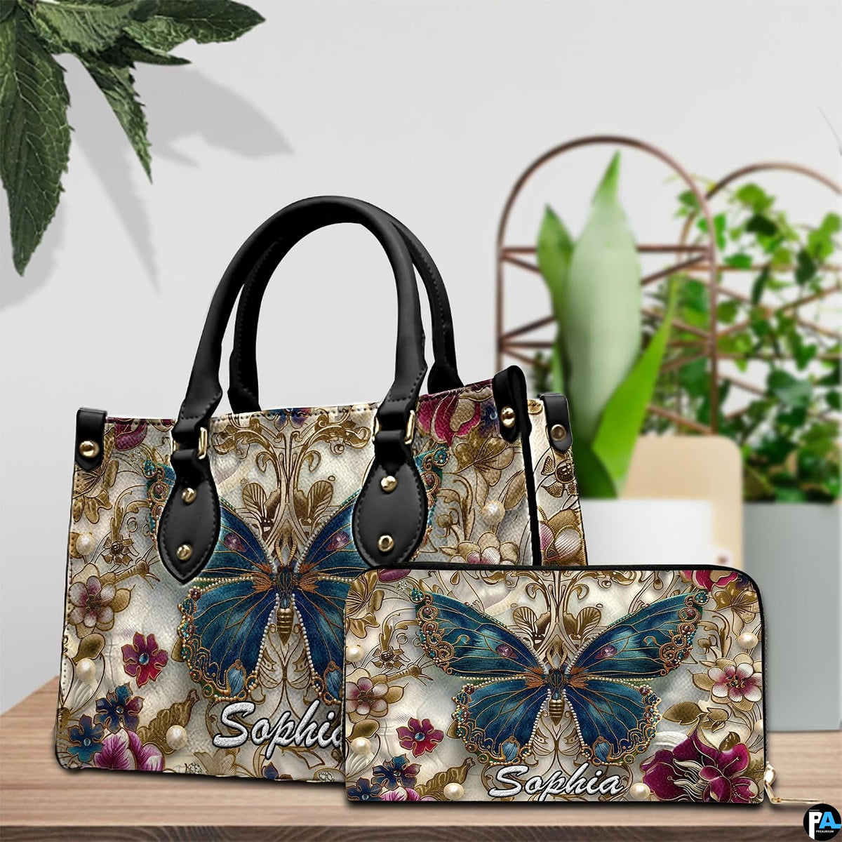 Close-up front view of handbag showing teal butterfly and gold scrollwork