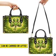 Two carry views of green Celtic clover handbag