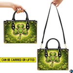 Two carry views of green Celtic clover handbag