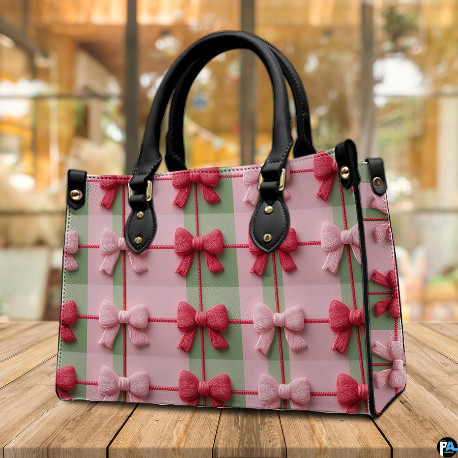 Atmospheric indoor tabletop display of the pink and green gingham bow artwork on wooden surface