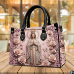 Tabletop display of Virgin Mary handbag highlighting sculpted pink roses and crowned figure