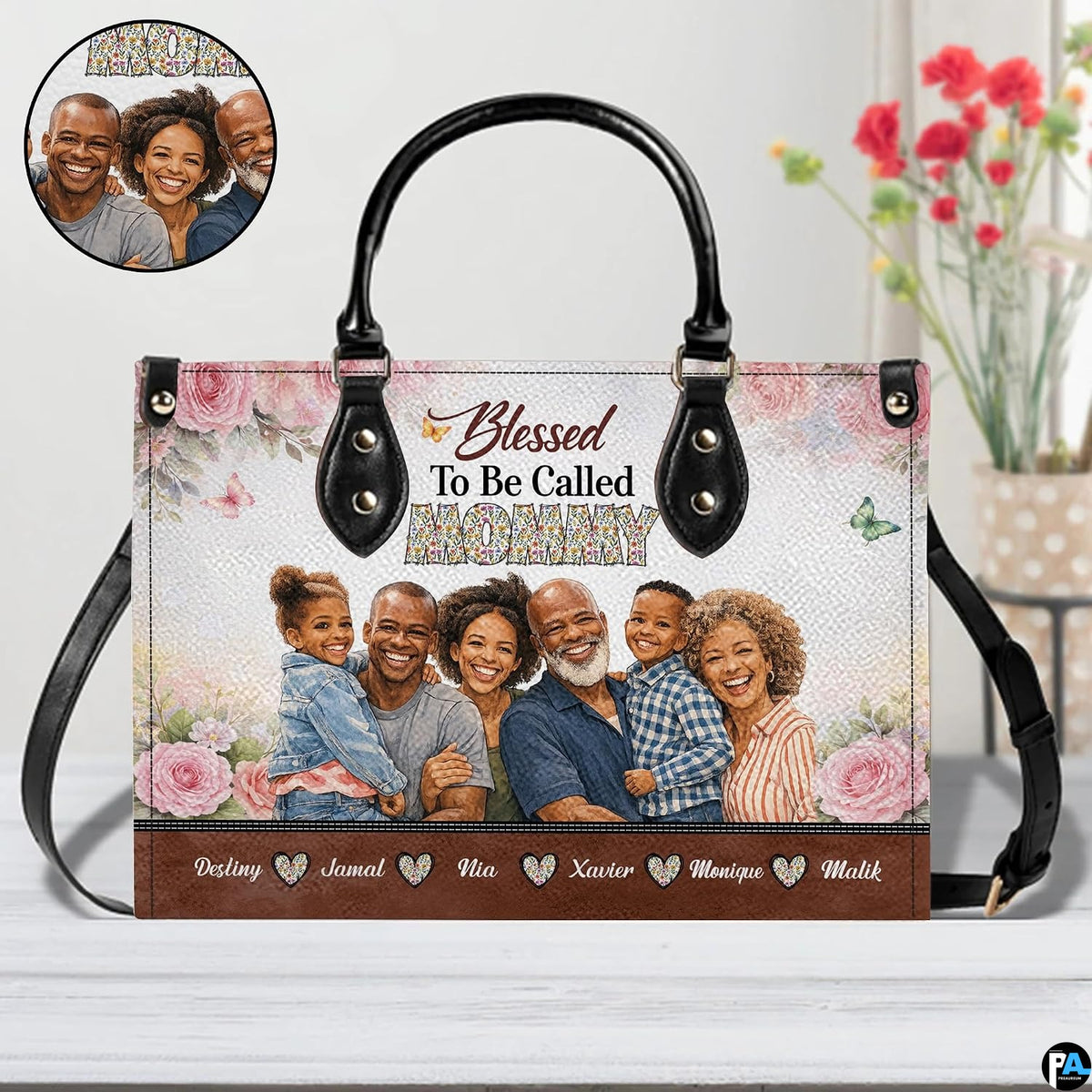 Side profile view of structured floral handbag showing sleek silhouette and black carrying handles.