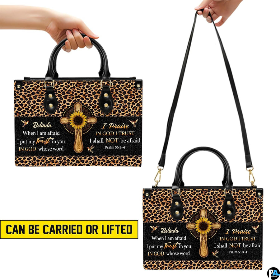 Top view showing black carrying handles and main zippered opening of animal print cross purse.
