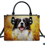 Demonstration of canine pet portrait artwork on upright handbag amidst blooming yellow flowers.