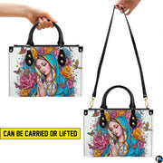 Carrying versatility display of Virgin Mary handbag showing handheld and shoulder strap modes.