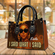 Angled display view of the afro queen handbag set atop a wooden surface in a bright interior.