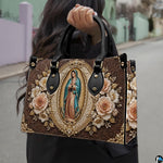 Model carrying baroque Our Lady of Guadalupe bronze relief handbag outdoors