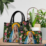 Virgin Mary floral handbag and coordinated wallet set displayed on wooden surface