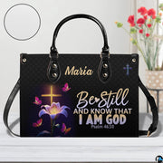 Front view of glowing cross and lily handbag with inset circle showing textured surface detail.