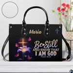 Front view of glowing cross and lily handbag with inset circle showing textured surface detail.