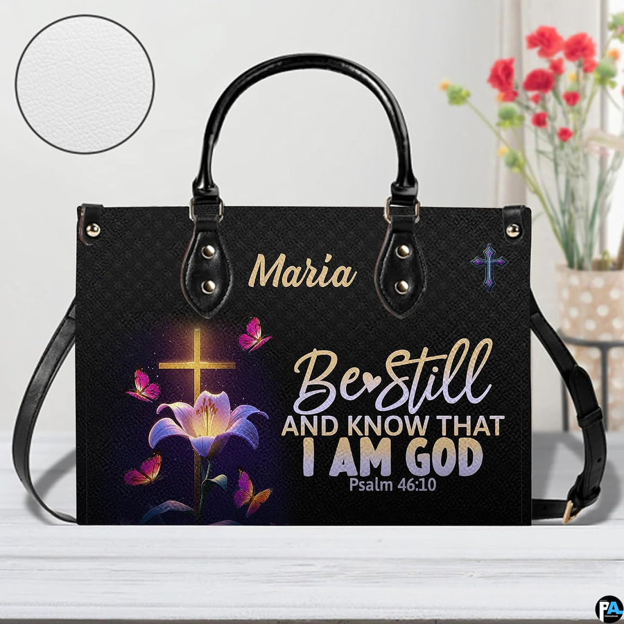 Front view of glowing cross and lily handbag with inset circle showing textured surface detail.