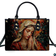 Isolated studio presentation of terracotta mosaic Praying Virgin Mary handbag on white backdrop.