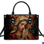 Isolated studio presentation of terracotta mosaic Praying Virgin Mary handbag on white backdrop.