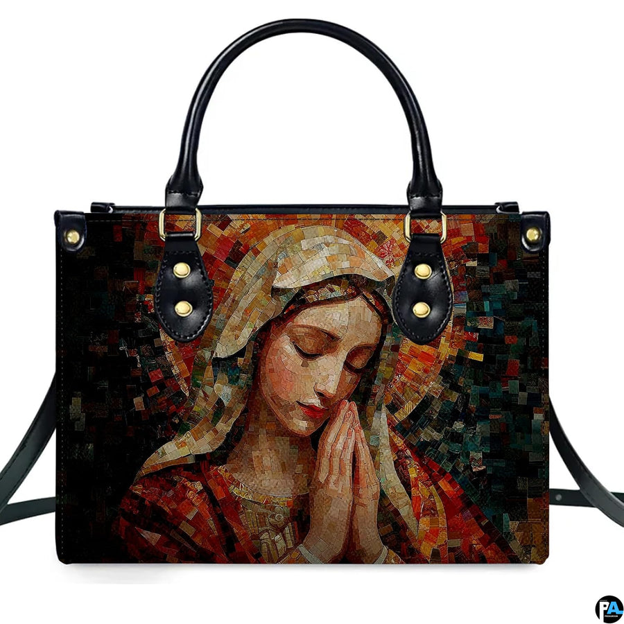 Isolated studio presentation of terracotta mosaic Praying Virgin Mary handbag on white backdrop.