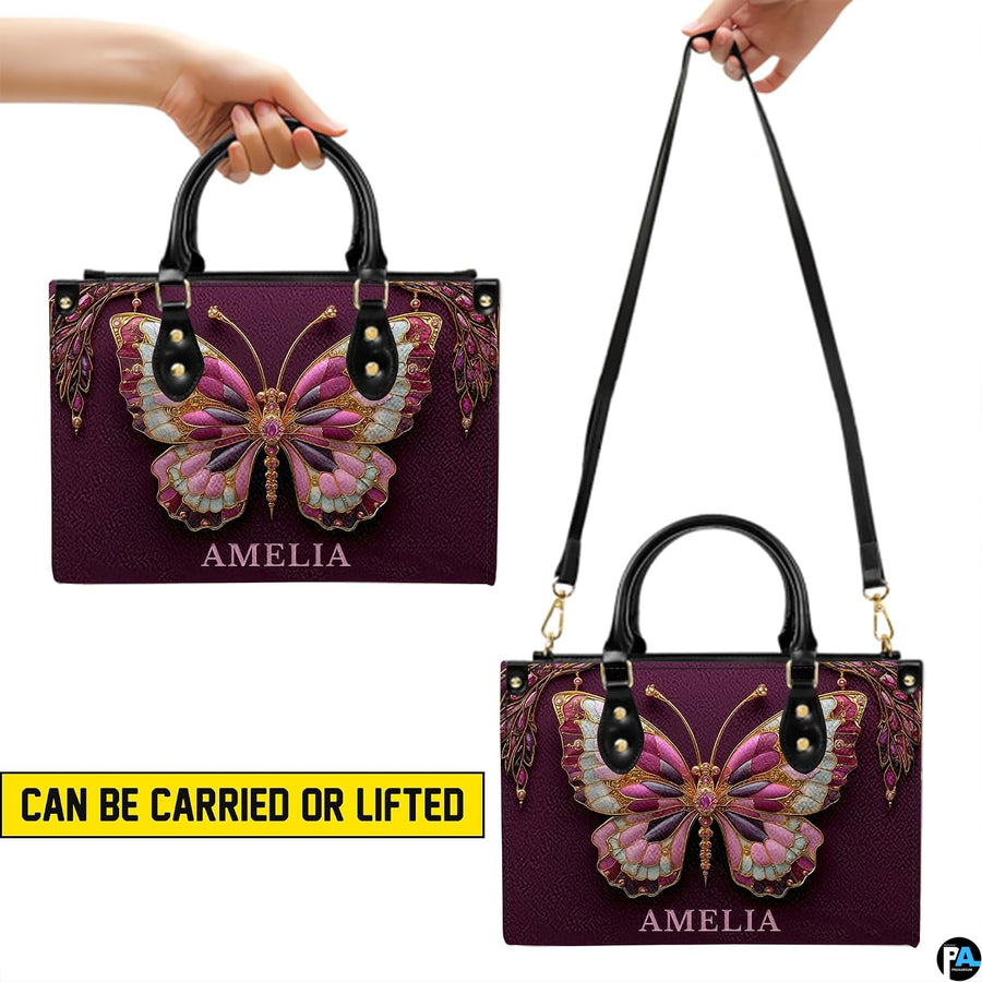 Bottom view of plum butterfly handbag showing flat rectangular base