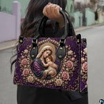 Outdoor presentation of the royal purple Madonna and Child artwork handbag held by model