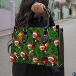 Street lifestyle view of holiday handbag with all-over evergreen pine and Santa cat print carried by hand