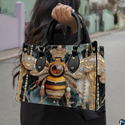 Front view of jeweled bee handbag showing golden crown and deep emerald marble pattern.