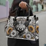 Outdoor street view of monochrome sketch Highland cow floral design carried by hand