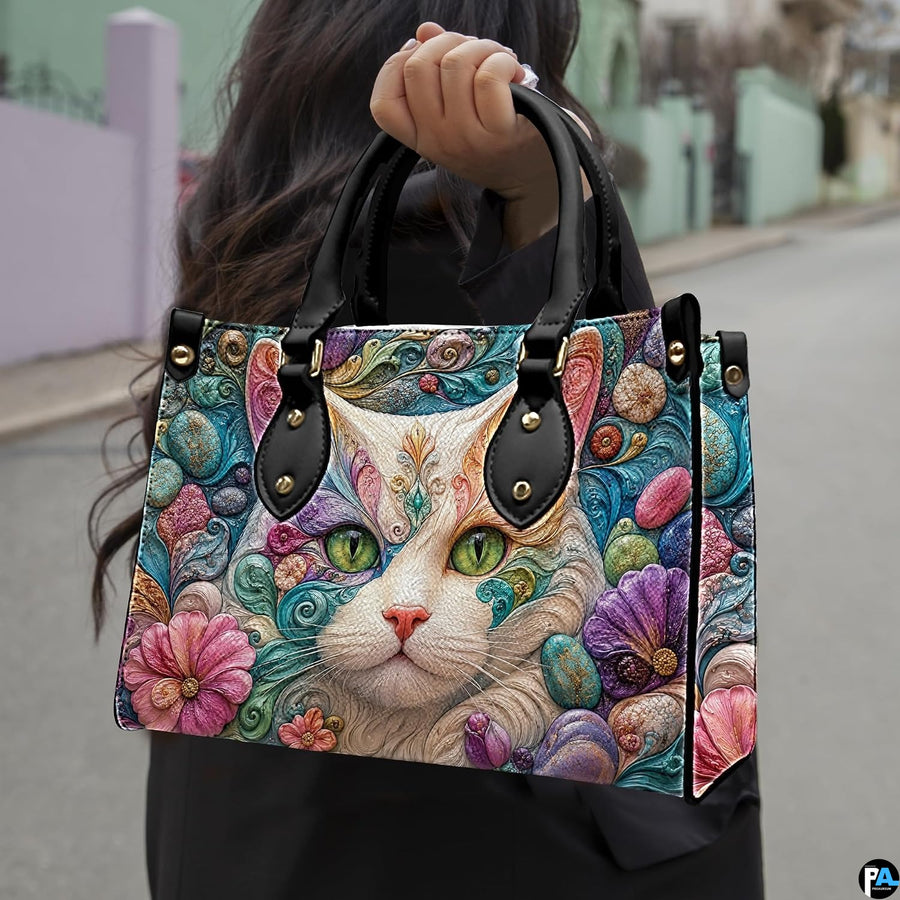 Outdoor presentation showing white cat sculpted filigree artwork held during an urban walk.