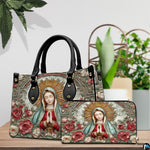 Our Lady of Guadalupe handbag and matching zippered wallet displayed on wooden table.