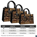 Library themed handbag and matching wallet set styled on a wooden tabletop with green plants.