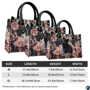 Side perspective view of black kitten rose relief handbag and wallet