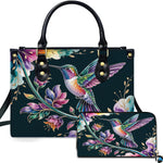 Midnight teal handbag and matching wallet set featuring an iridescent hummingbird and watercolor flowers.