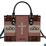 Side profile view of structured faith crystal cross handbag.