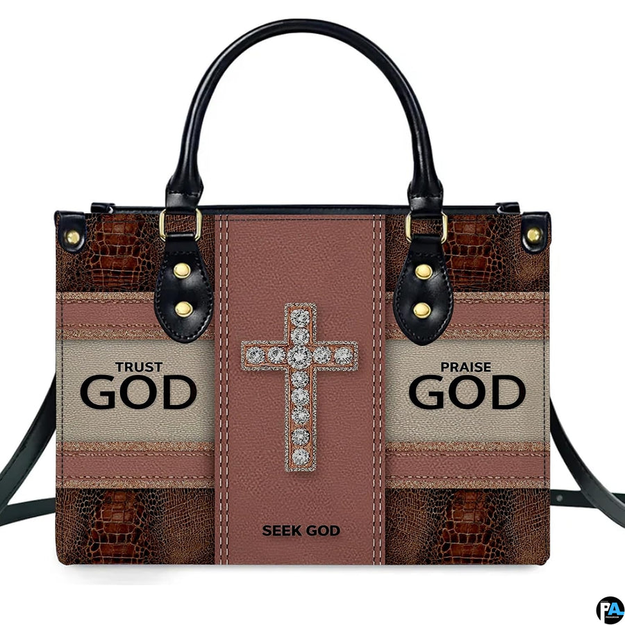 Side profile view of structured faith crystal cross handbag.