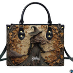Gothic autumn witch broomstick handbag shown alone on white background.