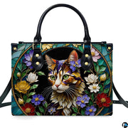 Front studio shot of stained glass cat portrait and floral medallion.